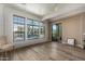 Spacious living room with hardwood floors, large windows and access to balcony at 7297 N Scottsdale Rd # 1004, Paradise Valley, AZ 85253