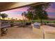Outdoor patio with built-in grill, offering sunset views of the golf course at 2606 N 159Th Dr, Goodyear, AZ 85395