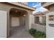 View of the garage entry with a paved walkway and arched entryway at 2606 N 159Th Dr, Goodyear, AZ 85395