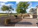 Landscaped backyard with patio and golf course views at 2606 N 159Th Dr, Goodyear, AZ 85395