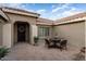 Courtyard with a small table and chairs, providing a peaceful outdoor space at 2606 N 159Th Dr, Goodyear, AZ 85395
