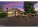 House exterior view showcasing backyard and landscaping at sunset at 2606 N 159Th Dr, Goodyear, AZ 85395