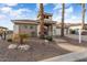 Single-story home with desert landscaping, an arched entryway, and two palm trees at 2606 N 159Th Dr, Goodyear, AZ 85395