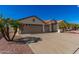 Single-story home with tan exterior and palm trees at 2222 S Yellow Wood --, Mesa, AZ 85209