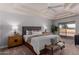 Main bedroom with wood bed frame and sliding glass doors to patio at 2222 S Yellow Wood --, Mesa, AZ 85209
