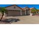 Single-story home with tan exterior and palm trees at 2222 S Yellow Wood --, Mesa, AZ 85209