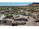 Aerial view of a house with a landscaped yard and surrounding mountain views at 4126 S Last Chance Trl, Gold Canyon, AZ 85118