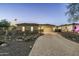 House exterior at dusk, featuring a paved driveway and landscaping at 4126 S Last Chance Trl, Gold Canyon, AZ 85118