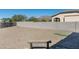 Large backyard with gravel, a bench, and a putting green at 4126 S Last Chance Trl, Gold Canyon, AZ 85118