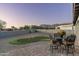 Spacious backyard with putting green, patio furniture, and mountain views at 4126 S Last Chance Trl, Gold Canyon, AZ 85118