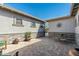 Brick paved courtyard with stone wall, wrought iron furniture, and sunburst wall art at 4126 S Last Chance Trl, Gold Canyon, AZ 85118