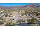 Aerial view of a house and surrounding neighborhood in mountain setting at 4126 S Last Chance Trl, Gold Canyon, AZ 85118