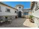 Courtyard entry with seating, stonework, and a decorative sun at 4126 S Last Chance Trl, Gold Canyon, AZ 85118