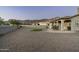 Large backyard with putting green, patio, and gravel landscaping at 4126 S Last Chance Trl, Gold Canyon, AZ 85118