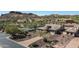 Aerial view of a house with a landscaped yard and a paved driveway at 4126 S Last Chance Trl, Gold Canyon, AZ 85118