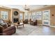 Spacious living room with leather furniture, a fireplace, and large windows at 4126 S Last Chance Trl, Gold Canyon, AZ 85118