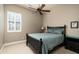 Charming bedroom with a full-size bed, ceiling fan, and window shutters at 4126 S Last Chance Trl, Gold Canyon, AZ 85118