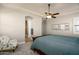 Spacious bedroom with a king-size bed, an armchair, and access to a bathroom at 4126 S Last Chance Trl, Gold Canyon, AZ 85118