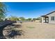 Landscaped backyard with putting green, gravel, and a covered patio at 4126 S Last Chance Trl, Gold Canyon, AZ 85118