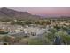 Aerial view of house with putting green and mountain backdrop at 4126 S Last Chance Trl, Gold Canyon, AZ 85118