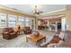 Open concept living room with leather furniture and kitchen access at 4126 S Last Chance Trl, Gold Canyon, AZ 85118
