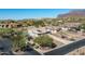 Aerial view of a house and surrounding community with mountain views at 4126 S Last Chance Trl, Gold Canyon, AZ 85118