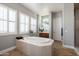 Large bathroom with soaking tub, double vanity, and neutral tile flooring at 4126 S Last Chance Trl, Gold Canyon, AZ 85118