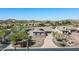 Aerial view of house and surrounding neighborhood in desert landscape at 4126 S Last Chance Trl, Gold Canyon, AZ 85118