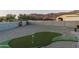 Landscaped backyard with putting green and mountain views at 4126 S Last Chance Trl, Gold Canyon, AZ 85118