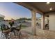 Covered patio with seating area overlooking putting green at 4126 S Last Chance Trl, Gold Canyon, AZ 85118