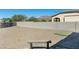 Landscaped backyard with putting green and bench at 4126 S Last Chance Trl, Gold Canyon, AZ 85118