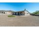 Large backyard with putting green, gravel, and partial home view at 4126 S Last Chance Trl, Gold Canyon, AZ 85118