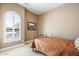 Cozy bedroom with a queen-size bed and large window with shutters at 4126 S Last Chance Trl, Gold Canyon, AZ 85118