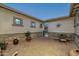 A paved courtyard with seating area, stone accents, and potted plants at 4126 S Last Chance Trl, Gold Canyon, AZ 85118