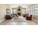 Living room with leather furniture and a fireplace, open to kitchen at 4126 S Last Chance Trl, Gold Canyon, AZ 85118