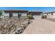 Single-story home with gray exterior, brick driveway, and landscaped front yard at 4126 S Last Chance Trl, Gold Canyon, AZ 85118
