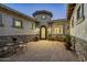 Elegant courtyard entry with sitting area and ornate door at 4126 S Last Chance Trl, Gold Canyon, AZ 85118
