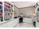 Spacious home office with built-in shelving and a large desk at 24426 S Ribbonwood Dr, Sun Lakes, AZ 85248