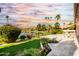 Landscaped backyard with patio and lake views at 24426 S Ribbonwood Dr, Sun Lakes, AZ 85248