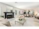 Spacious living room with a fireplace, seating area, and adjacent dining area at 24426 S Ribbonwood Dr, Sun Lakes, AZ 85248