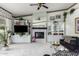 Spacious living room with a fireplace and built-in entertainment center at 24426 S Ribbonwood Dr, Sun Lakes, AZ 85248