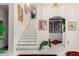 Elegant staircase with a library and artwork visible in background at 24426 S Ribbonwood Dr, Sun Lakes, AZ 85248