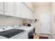 Well-equipped laundry room with washer, dryer, and ample cabinetry at 24426 S Ribbonwood Dr, Sun Lakes, AZ 85248