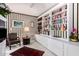 Charming study with built-in bookcases and a comfortable armchair at 24426 S Ribbonwood Dr, Sun Lakes, AZ 85248