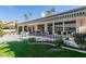 Large covered patio with seating area, overlooking the grassy backyard at 24426 S Ribbonwood Dr, Sun Lakes, AZ 85248