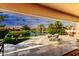Large patio overlooking a lake with seating for outdoor dining at 24426 S Ribbonwood Dr, Sun Lakes, AZ 85248