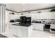 Modern kitchen with white cabinets, granite countertops, and stainless steel appliances at 24426 S Ribbonwood Dr, Sun Lakes, AZ 85248