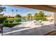 Covered patio with seating and serene lake view at 24426 S Ribbonwood Dr, Sun Lakes, AZ 85248