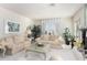 Comfortable living room with beige sofas and a glass-top coffee table at 24426 S Ribbonwood Dr, Sun Lakes, AZ 85248