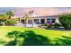 Landscaped backyard with pool and patio; great for entertaining at 24426 S Ribbonwood Dr, Sun Lakes, AZ 85248